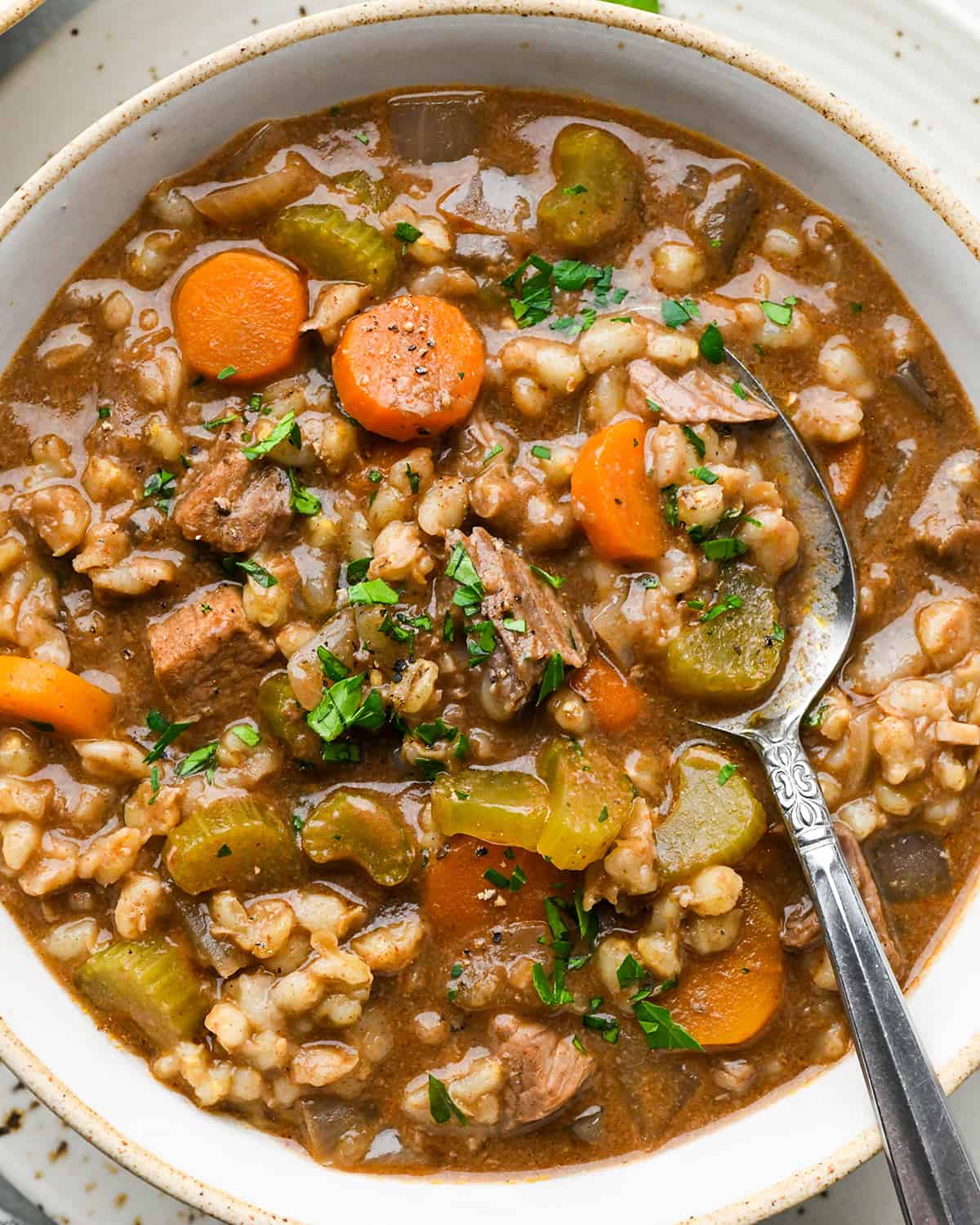 a bowl of Beef Barley Soup with a spoon