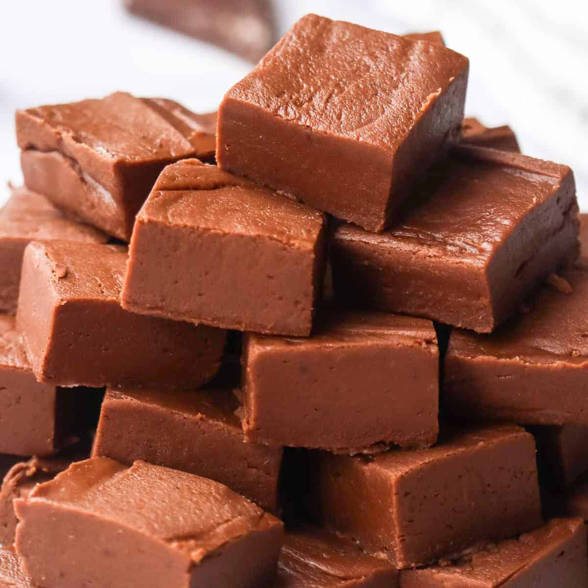 a stack of homemade chocolate fudge cut squares