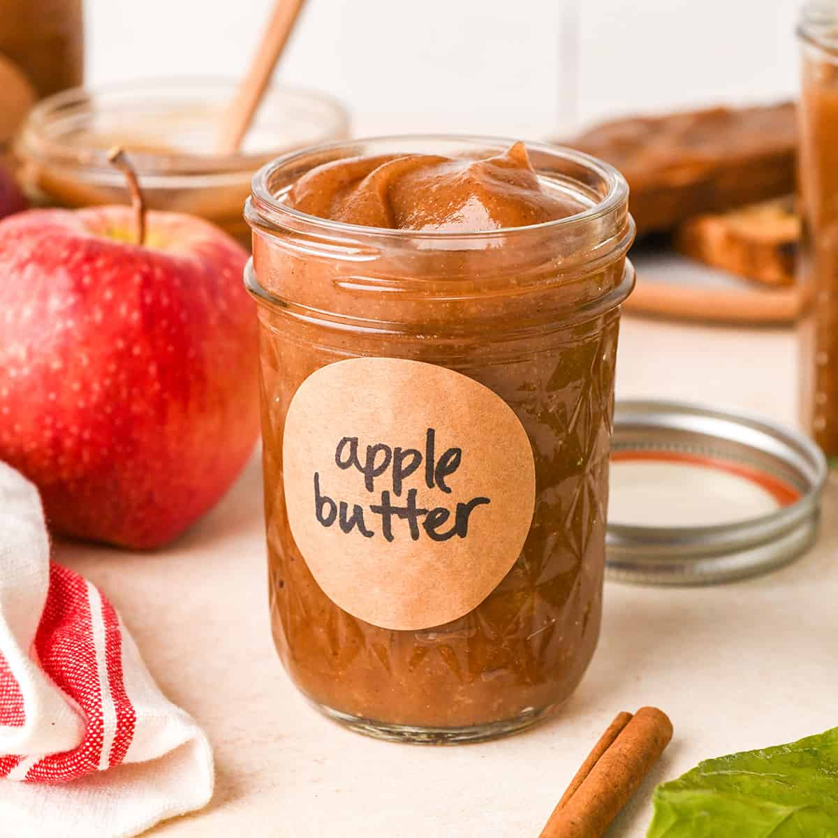 a glass jar of Homemade Apple Butter with a label