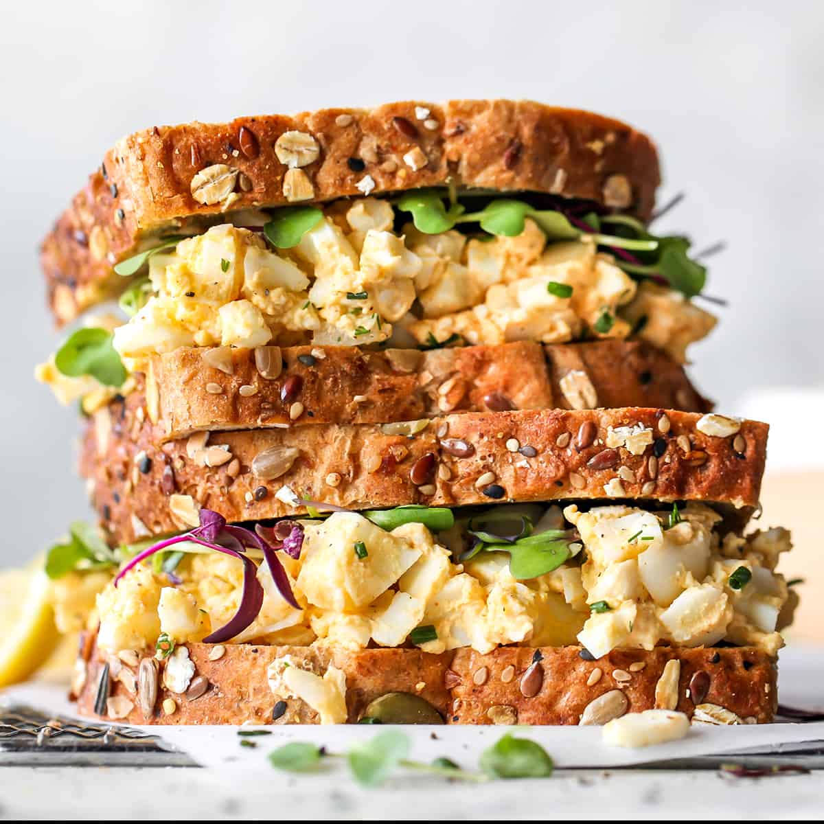 photo of two egg salad sandwiches stacked on each other 